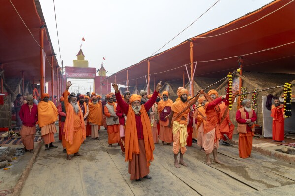 Hindu holy men arrive in a procession at an akhara where they will stay during the 45-day-long Maha Kumbh festival beginning on Jan. 13, at the confluence of the Ganges, the Yamuna and the mythical Saraswati rivers, in Prayagraj, India, Sunday, Jan. 12, 2025. (AP Photo/Ashwini Bhatia)